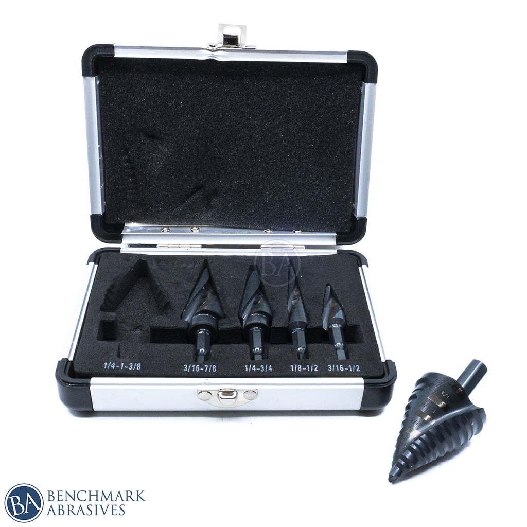 Open metal case displaying five spiral step drill bits with one bit lying beside it